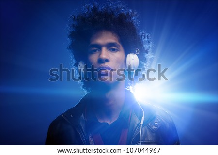 Confident dj portrait with club lights lens flare and retro man with afro and headphones