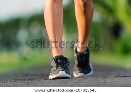 feet of an athlete running on a park pathway training for fitness and healthy lifestyle