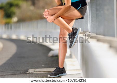knee injury for athlete runner. woman in pain after hurting her leg while training for fitness marathon