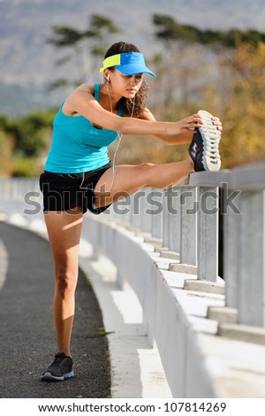 woman runner stretching leg muscle before running outdoors for athlete training.