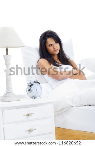Woman unhappy to wake up early is reluctant to get out of bed isolated on white background