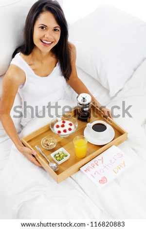 Happy mothers day breakfast in bed mum with card and tray of delicious food