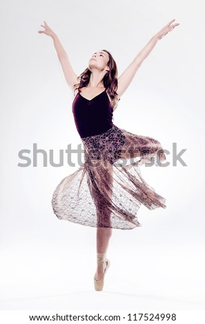 beautiful ballet dancer woman isolated in motion with movement and perfect arabesque
