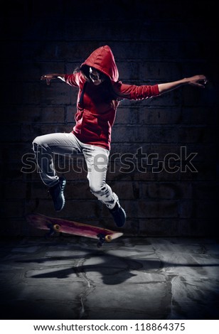 Skateboarder doing trick with grunge background red hoodie and skill