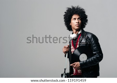 Music dj portrait with afro and headphones isolated on grey background