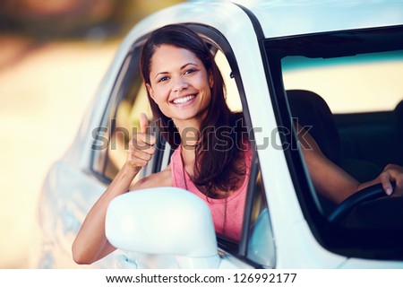 carefree woman driving car on vacation happy smile holiday