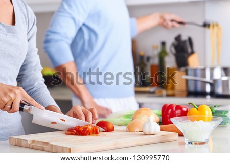 couple cooking healthy food in kitchen lifestyle meal preparation