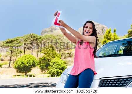 Confident learner driver girl proud of passing her test with car