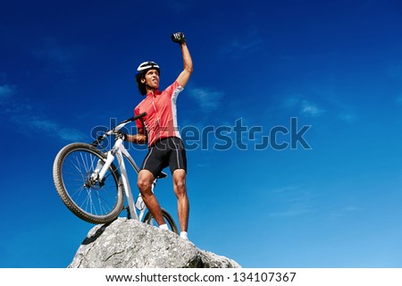 confident mountain bike man celebrating making the top of the peak happy and cheerful confident mountain bike man celebrating making the top of the peak happy and cheerful