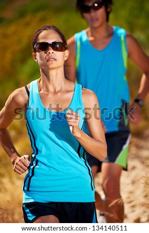 couple running together training for marathon and fitness