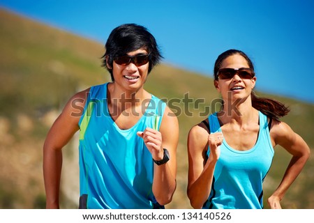 couple running together training for marathon and fitness