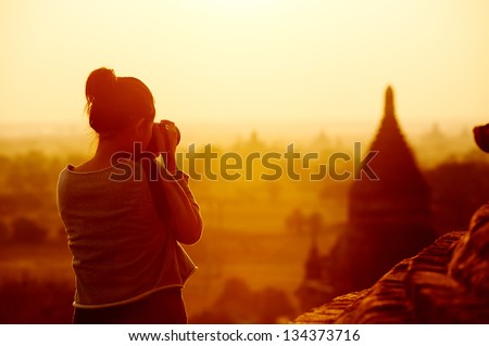 Female Traveler Photographing Temples At Bagan Myanmar Asia At Sunrise