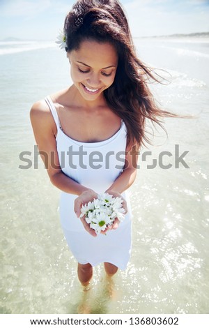 gorgeous woman with daisy flowers portrait at beach