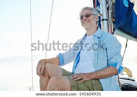 relaxing man sitting on boat sailing on ocean happy and carefree