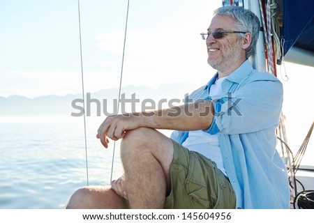 relaxing man sitting on boat sailing on ocean happy and carefree
