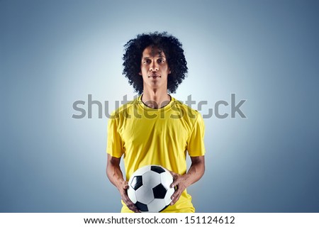 Portrait of Brazilian soccer football player with ball and national kit ready for the world cup
