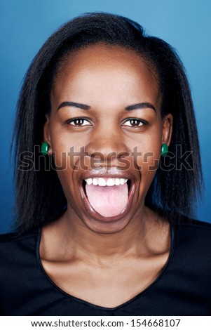 portrait of real funny face african woman on blue background - Stock Image  - Everypixel