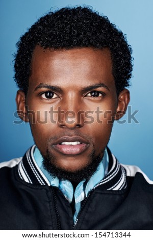 portrait of natural real african man on blue background portrait of natural real african man on blue background