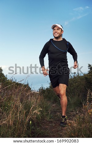 happy running man on trail exercising outdoors