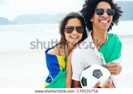 Portrait Of Latino Couple With Brasil Flag And Soccer Ball For World Cup