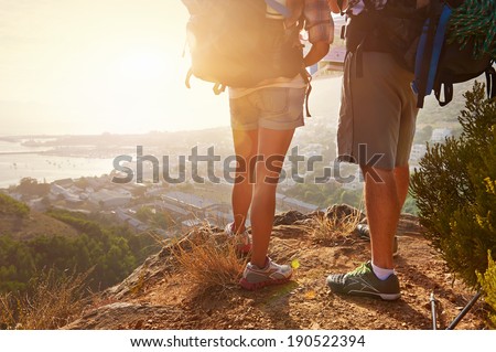 Cropped image of two hikers legs standing on a hiking path and looking at the view