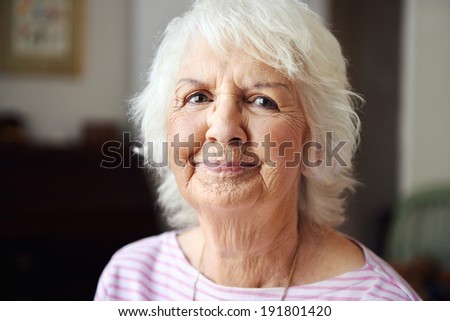 A beautiful senior woman looking at the camera with pursed lips