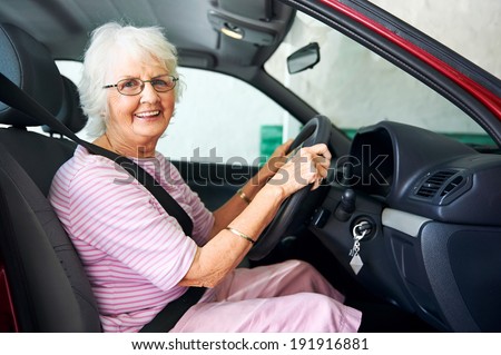 Portrait of a smiling aging woman sitting in a vehicle