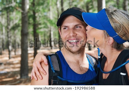 Healthy active couple kiss portrait in fitness gear