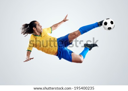 soccer player kicking ball towards goal for score and glory in brazil world cup