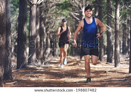 Fit marathon couple trail running together for sport and healthy living Fit marathon couple trail running together for sport and healthy living