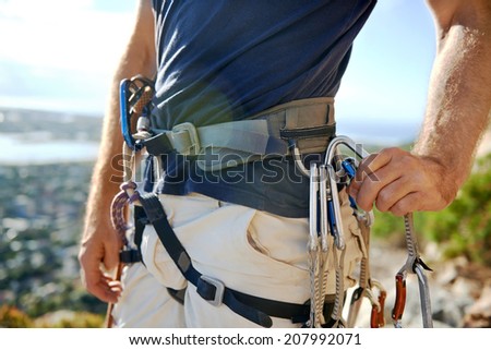 Close up of a man in his harness and rock climbing equipment