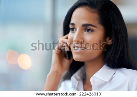 young businesswoman on phone call in office happy and smiling