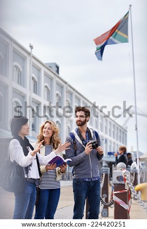 South Africa tourism couple with guide book on vacation holiday