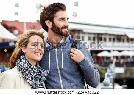 couple traveling together having fun near ferris wheel attraction