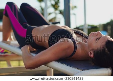 fitness woman doing situps in outdoor gym woking out strength training