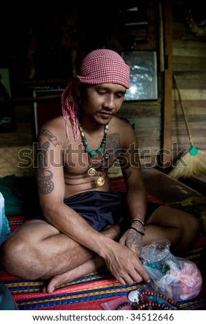 PHI PHI ISLAND, THAILAND – CIRCA DECEMBER 2008: A local necklace maker in his home on circa December 2008 in Phi Phi island. The island was devastated by Tsunami and people are rebuilding their lives.
