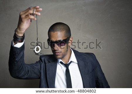 Sharp modern man looks at his old pocket watch