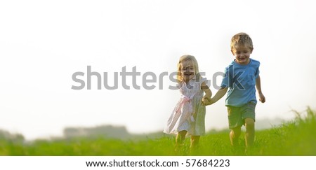 stock photo : Young girl runs through a field, happy and having fun.