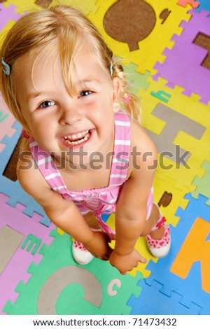 stock photo young blonde girl smiles as she learns the alphabet at 