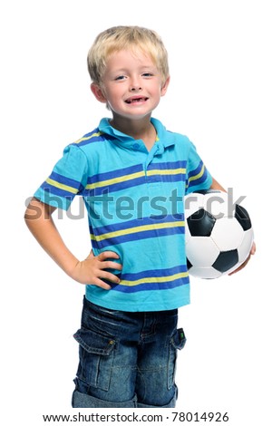Happy boy stands with a football, aspiring to be a professional soccer player