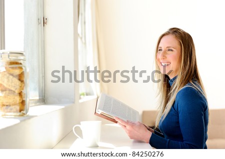 Pretty woman enjoying some quiet time, relaxing with her book