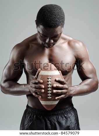 Serious portraits of a black american football sportsman in studio