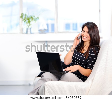 Beautiful woman chatting on the phone while surfing the internet