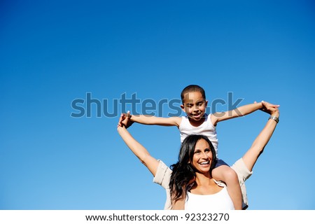 Mom and son happy and free outdoors in the blue sky. carefree cheerful concept