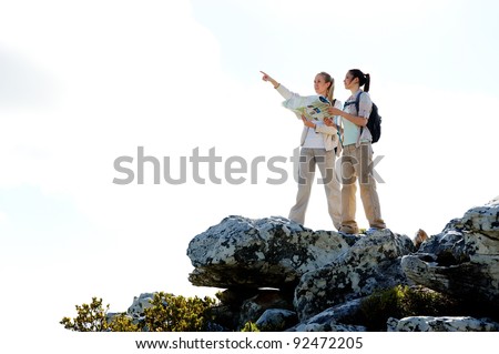 hikers with map pointing in the right direction