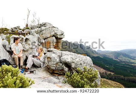 Panorama of two friends making camp after a long hike outdoors in the mountains. large file with copyspace ideal for double page spread or billboard use