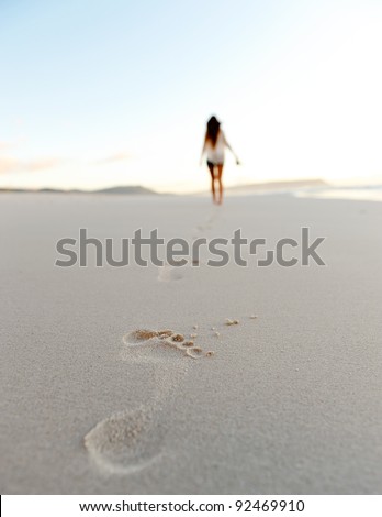 woman walks alone on a deserted beach, solitude, serene, lonely concept. carefree vacation in nature