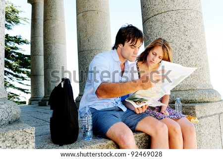 couple use a map to find out where they are. young couple traveling and exploring old ruins, temples and monuments