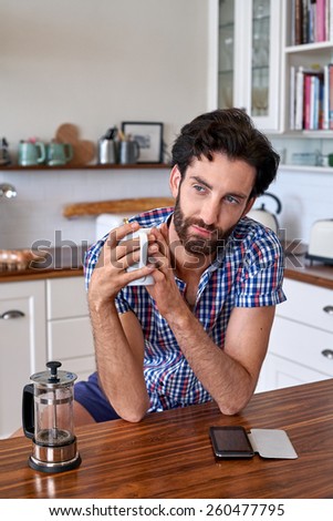 man enjoying french press filter coffee at home kitchen