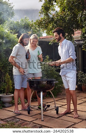 man helping at the outdoor garden barbeque with a plate while man serves healthy chicken meat